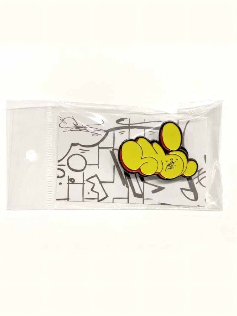 Colorful "Peace" pin with yellow and black design on white background.